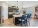 Spacious kitchen with dark cabinets, a large center island, and modern pendant lighting at 605 San Augusto Dr, Kissimmee, FL 34759