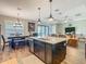Open-concept kitchen with island seating, stainless steel appliances, and a dining area at 605 San Augusto Dr, Kissimmee, FL 34759