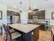 Stylish kitchen with a large center island, modern appliances, and dark cabinets at 605 San Augusto Dr, Kissimmee, FL 34759