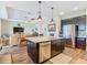 Open-concept kitchen with a large island, stainless steel appliances, and a view to the living area at 605 San Augusto Dr, Kissimmee, FL 34759