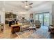Open-concept living room with kitchen view, comfortable seating, and sliding glass doors to the patio at 605 San Augusto Dr, Kissimmee, FL 34759