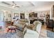 Open-concept living area showcases modern kitchen, dining, and Gathering room with wood-look tile floors at 605 San Augusto Dr, Kissimmee, FL 34759