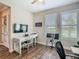 Office space featuring hardwood floors, two windows, a desk, and view to the outside at 605 San Augusto Dr, Kissimmee, FL 34759