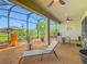 Large screened-in patio with outdoor furniture, plants, and lots of space for relaxing at 605 San Augusto Dr, Kissimmee, FL 34759