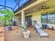 Covered outdoor patio featuring dining and relaxing areas surrounded by tropical plants at 605 San Augusto Dr, Kissimmee, FL 34759