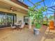 Covered and screened outdoor patio with dining and relaxing areas with sliding glass doors at 605 San Augusto Dr, Kissimmee, FL 34759