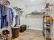 Well-organized walk-in closet with wood-style tile flooring, wire shelving, and convenient space for storage and organization at 605 San Augusto Dr, Kissimmee, FL 34759