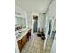 Spacious bathroom with a vanity, large mirror, and walk-in shower at 651 Elderwood Ct, Kissimmee, FL 34743