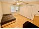 Bedroom with wood floors, a bed, and white closet doors with air conditioner at 651 Elderwood Ct, Kissimmee, FL 34743