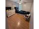 Bedroom with wood floor, ceiling fan, dresser and large window at 651 Elderwood Ct, Kissimmee, FL 34743