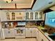 Bright kitchen with granite countertops, white cabinets, stainless steel appliances at 651 Elderwood Ct, Kissimmee, FL 34743