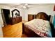 A main bedroom with a ceiling fan, wood floors, and furnishings at 651 Elderwood Ct, Kissimmee, FL 34743