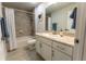 Well-lit bathroom features a shower-tub combo and a white vanity with ample storage at 6644 Sw 179Th Court Rd, Dunnellon, FL 34432