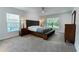 Large bedroom with two windows, a ceiling fan, two nightstands, and a dresser at 6644 Sw 179Th Court Rd, Dunnellon, FL 34432