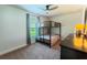 Cozy bedroom with carpet, a bunk bed, large window, and dresser with mirror at 6644 Sw 179Th Court Rd, Dunnellon, FL 34432