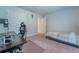 This carpeted bedroom features a built-in workspace, a bed, and a spacious closet at 6644 Sw 179Th Court Rd, Dunnellon, FL 34432