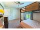 Bedroom with a bunk bed near the window, with a dresser, mirror, and spacious closet at 6644 Sw 179Th Court Rd, Dunnellon, FL 34432