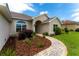 Close-up of a home's entrance featuring a decorative walkway and mature landscaping at 6644 Sw 179Th Court Rd, Dunnellon, FL 34432