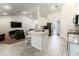 Open-concept kitchen featuring white cabinets, granite countertops, and eat-in island at 6644 Sw 179Th Court Rd, Dunnellon, FL 34432