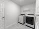 Clean, well-lit laundry room featuring modern, front-loading washer and dryer units at 6644 Sw 179Th Court Rd, Dunnellon, FL 34432