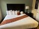 Bedroom with a large bed, stylish decor, and a bedside table with lamp at 7601 Canada Ave, Orlando, FL 32819