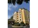 Hotel exterior featuring a covered entrance, manicured landscaping, and architectural details at 7601 Canada Ave, Orlando, FL 32819