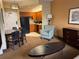 Cozy suite featuring a dining table, comfortable armchair, and a fully equipped kitchen at 7601 Canada Ave, Orlando, FL 32819