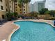 Inviting outdoor pool surrounded by lounge chairs and lush palm trees, perfect for relaxation at 7601 Canada Ave, Orlando, FL 32819
