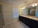 Bathroom with double sink vanity and walk-in shower at 1069 Pavia Dr, Apopka, FL 32703