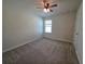 Bright bedroom features neutral carpet, ceiling fan, and a sunny window at 1069 Pavia Dr, Apopka, FL 32703