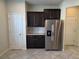 Updated kitchen featuring stainless steel refrigerator and dark wood cabinets at 1069 Pavia Dr, Apopka, FL 32703
