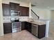 Kitchen with dark wood cabinets and stainless steel appliances at 1069 Pavia Dr, Apopka, FL 32703