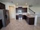 Open kitchen featuring stainless steel appliances and dark cabinetry at 1069 Pavia Dr, Apopka, FL 32703