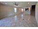 Open-concept living room with tiled flooring, ceiling fan, and staircase at 1069 Pavia Dr, Apopka, FL 32703