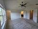 Spacious carpeted main bedroom with ceiling fan and two walk in closets at 1069 Pavia Dr, Apopka, FL 32703
