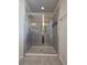 Bathroom features a modern shower stall with glass doors and tile surround at 1069 Pavia Dr, Apopka, FL 32703