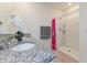 Bathroom featuring a granite vanity, a walk-in shower, and modern fixtures for a spa-like experience at 1102 Tupelo Trl, Haines City, FL 33844