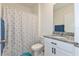 Cozy bathroom featuring a patterned shower curtain, granite countertop, and white vanity at 1102 Tupelo Trl, Haines City, FL 33844
