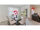 Inviting dining room with a glass table, comfortable chairs, and a view of the backyard, perfect for gatherings at 1102 Tupelo Trl, Haines City, FL 33844