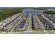 Wide aerial shot of a community near a lake showcasing orderly rows of houses with solar panels at 11328 Listening Dr, Orlando, FL 32832
