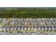 Aerial view of a residential neighborhood with tree lined street and pond nearby at 11328 Listening Dr, Orlando, FL 32832