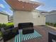 Inviting backyard patio with retractable awning and comfortable seating at 11328 Listening Dr, Orlando, FL 32832