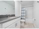 Bathroom featuring a sleek vanity with gray countertop, a toilet, and a shower with a striped curtain at 11328 Listening Dr, Orlando, FL 32832