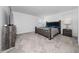 Carpeted bedroom with a gray bed frame and gray end tables at 11328 Listening Dr, Orlando, FL 32832