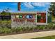 Stone sign marking Story Park community entrance with colorful pictorial icons at 11328 Listening Dr, Orlando, FL 32832