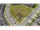 Overhead view of a dog park, surrounded by streets and homes, offering ample space for furry friends at 11328 Listening Dr, Orlando, FL 32832