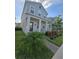 Inviting two-story home with a cozy front porch, neat landscaping, and a modern exterior design at 11328 Listening Dr, Orlando, FL 32832