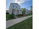Charming two-story home with covered porch, landscaped yard, and beautiful neighborhood views at 11328 Listening Dr, Orlando, FL 32832