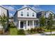 Charming two-story home with a covered porch, manicured lawn, and modern curb appeal at 11328 Listening Dr, Orlando, FL 32832