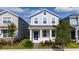 Inviting two-story home with a charming front porch and well-kept garden at 11328 Listening Dr, Orlando, FL 32832
